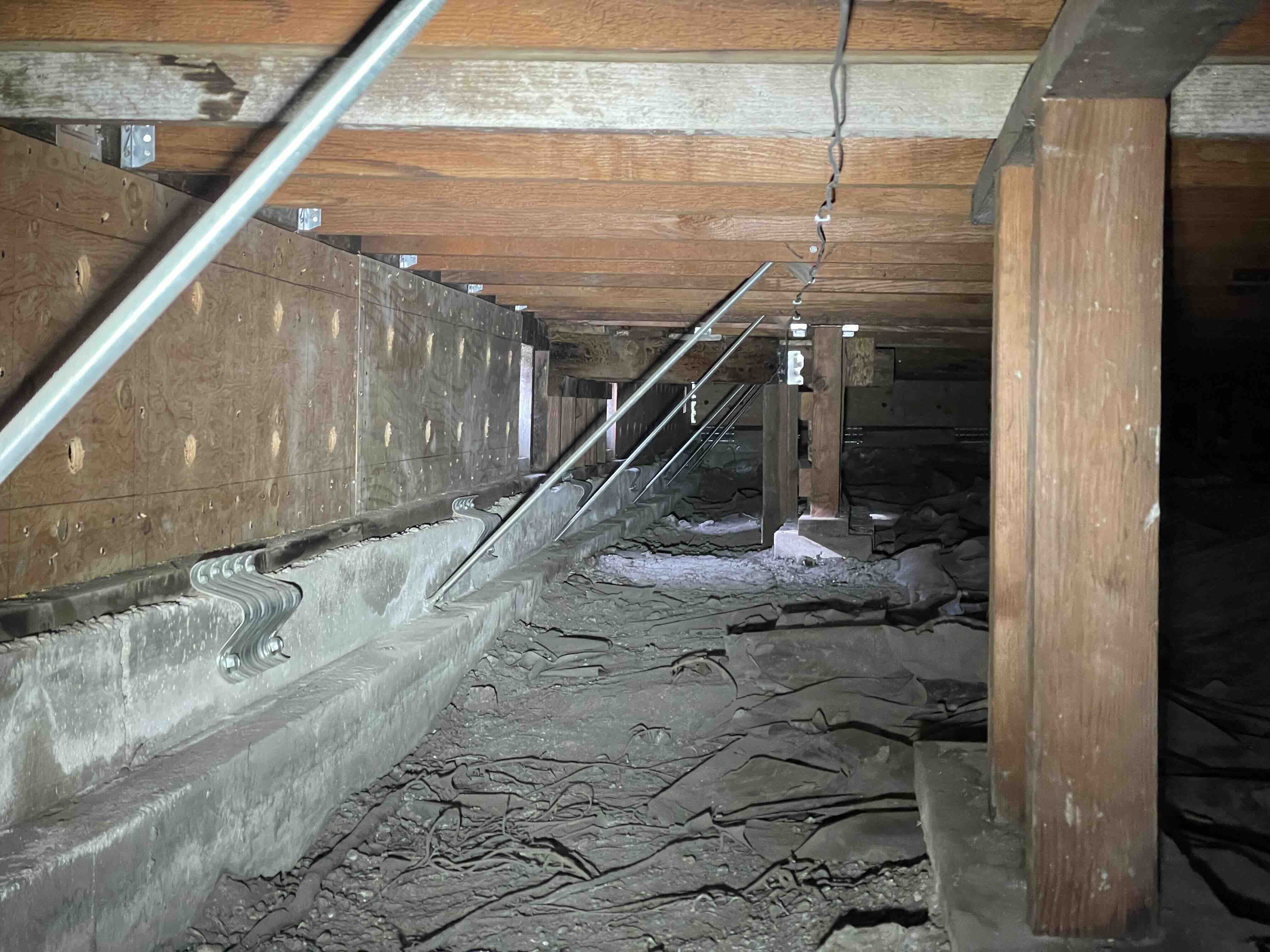 Plywood shear wall panels installed in a crawl space during a seismic retrofit